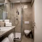 Hotelbadezimmer mit Dusche, Toilette und modernen Armaturen